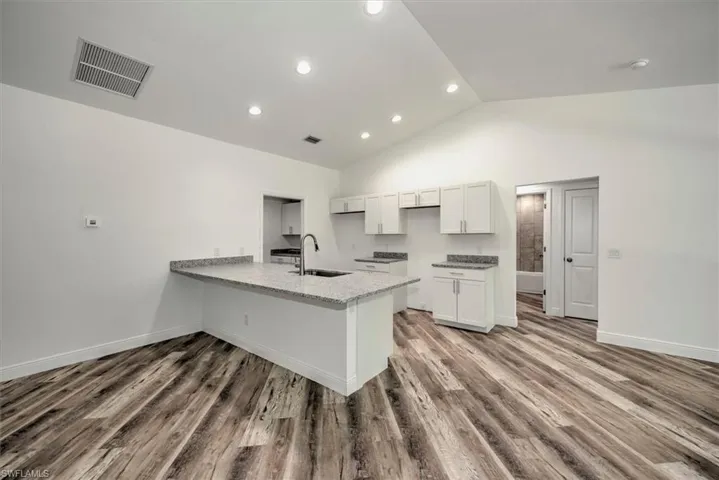Kitchen view with a breakfast bar that can easily seat 4