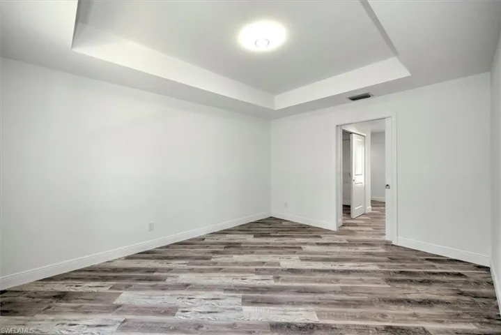 Master bedroom picture features a tray ceiling