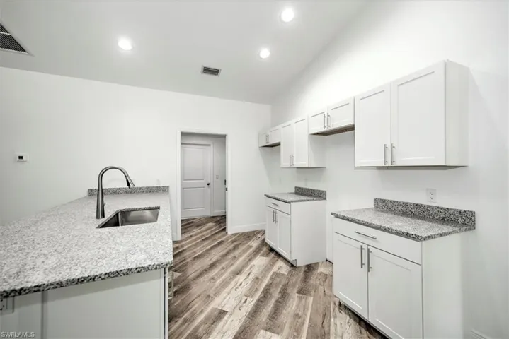 View of the kitchen that leads to the inside laundry area which doubles as a pantry.