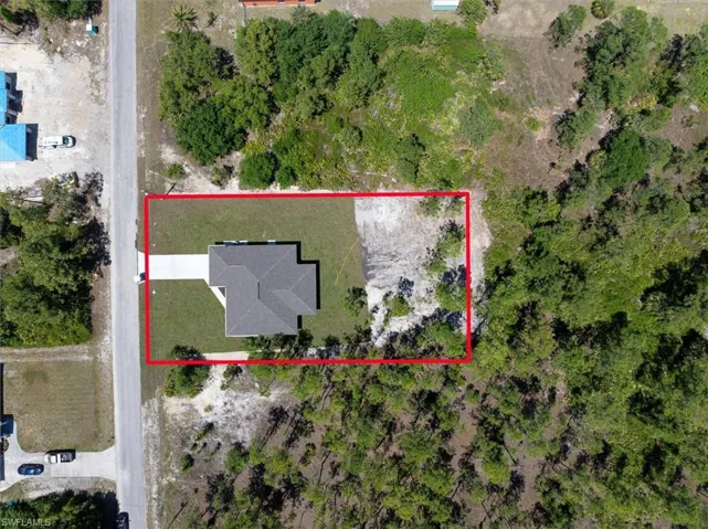 The huge backyard can serve for multiple uses. The back half was cleared sparing some pine trees giving you the opportunity to decide what you think would be best for you rather than a bare lot with no trees.