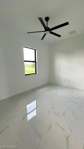 Spare room with ceiling fan