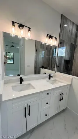 Bathroom with double sink vanity and ceiling fan