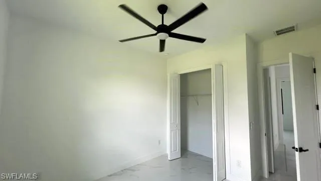 Unfurnished bedroom with a closet and ceiling fan