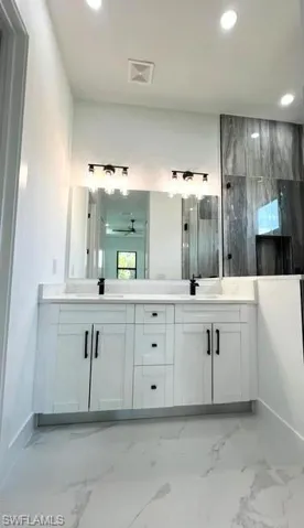 Bathroom with concrete floors and dual vanity