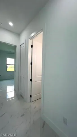 Hall featuring tile patterned floors