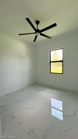 Spare room with ceiling fan