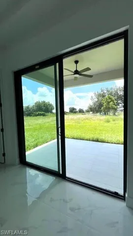 Doorway featuring plenty of natural light and ceiling fan
