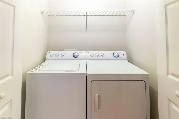 Washroom featuring washer and clothes dryer