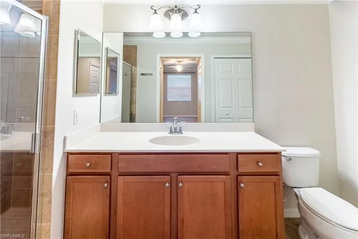 Bathroom featuring a shower stall and vanity