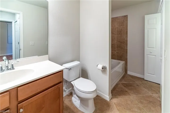 Full bathroom with vanity and light tile patterned flooring