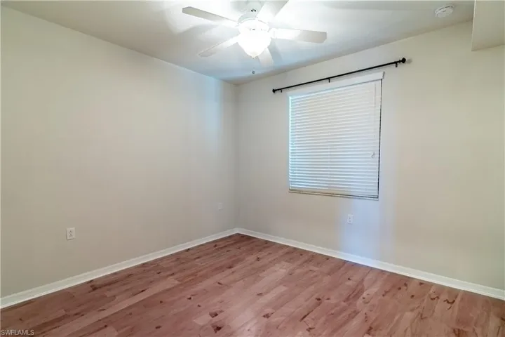 Empty room featuring wood finished floors and ceiling fan