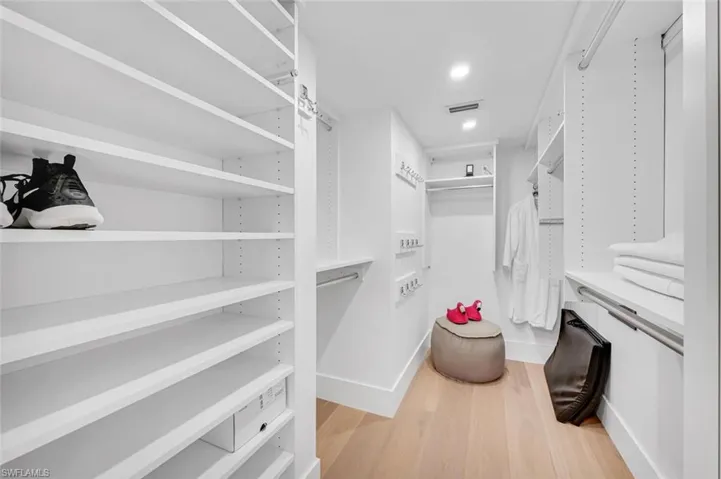Walk in closet featuring light wood-style flooring and visible vents