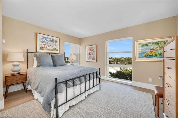 Bedroom featuring baseboards and wood finished floors