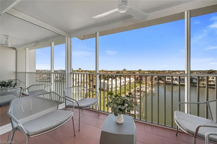 Sunroom featuring a water view
