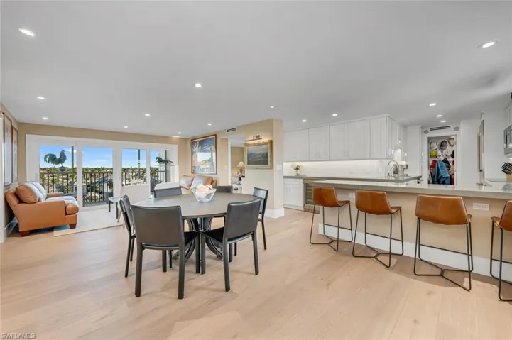 Dining space featuring recessed lighting, light wood-style floors, and beverage cooler