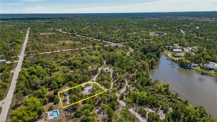 Aerial overview of property's location with a large body of water and property boundaries highlighted