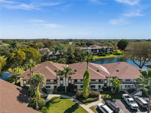 Drone / aerial view of a tree filled landscape and a large body of water