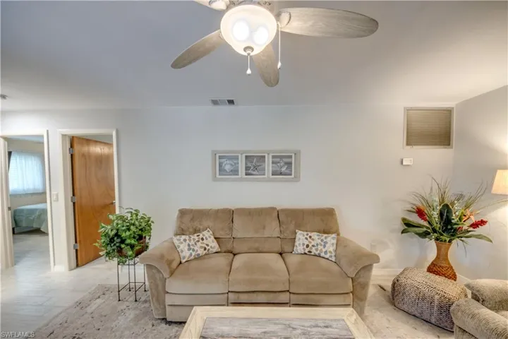 Living room featuring ceiling fan and light hardwood / wood-style floors