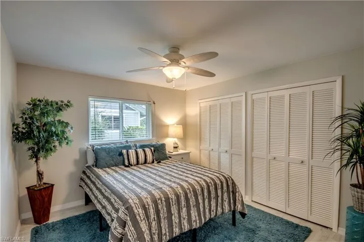 Bedroom with two closets and ceiling fan