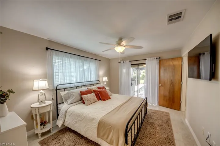 Bedroom featuring ceiling fan, light hardwood / wood-style flooring, and access to outside