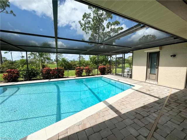 View of swimming pool with a lanai and a patio area