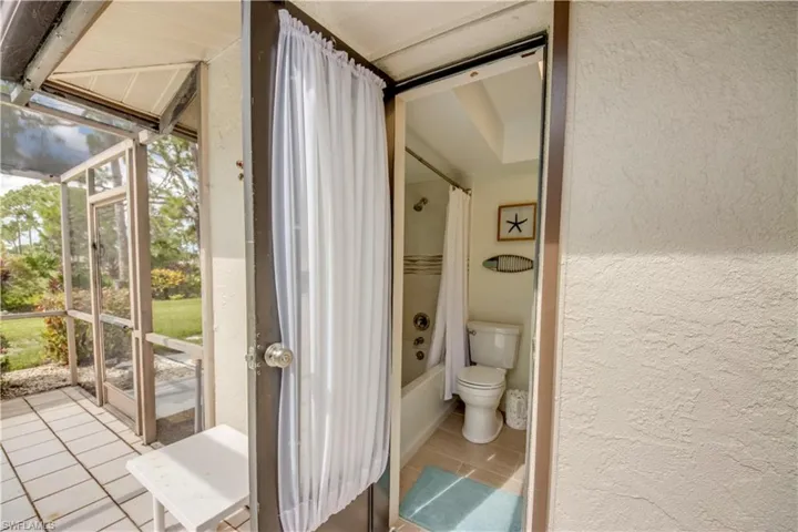 Bathroom with plenty of natural light, tile flooring, toilet, and shower / tub combo