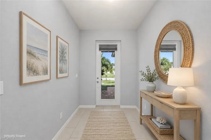 VIRTUALLY STAGED Foyer featuring neutral tile flooring and a glass-paneled exterior door with an integrated blind
