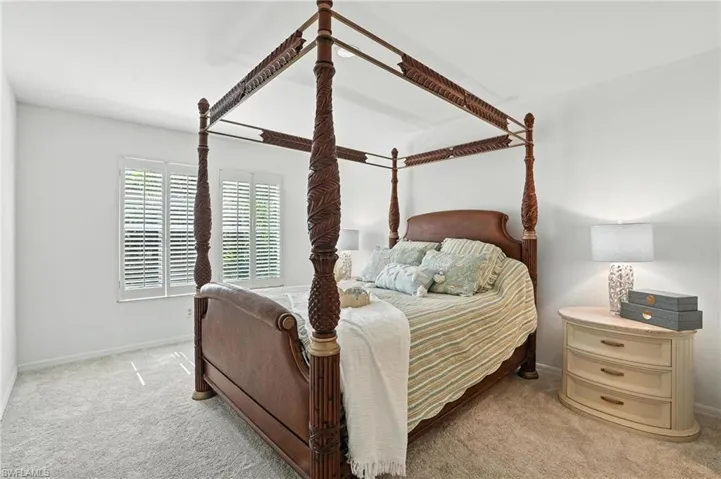 Carpeted bedroom featuring baseboards