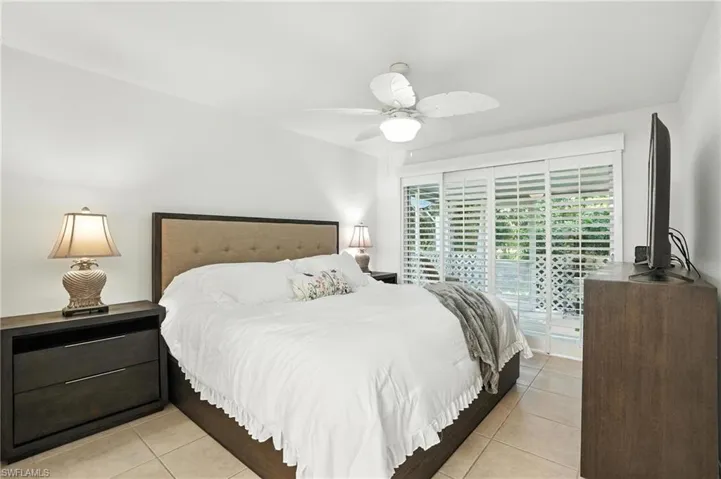Bedroom featuring light tile patterned floors and ceiling fan