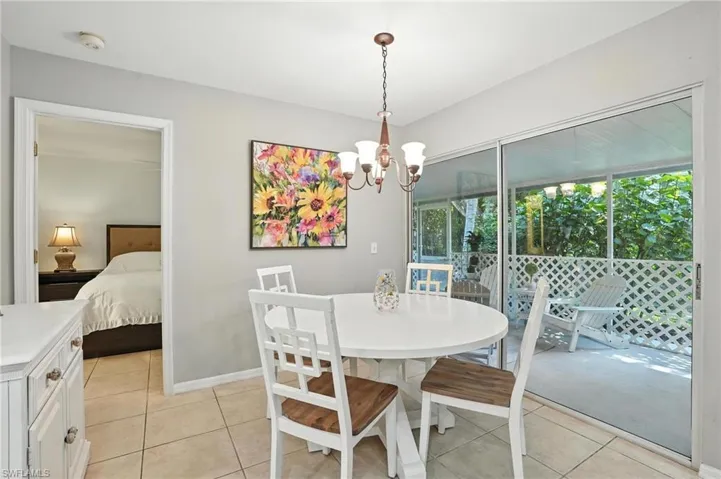 Dining space featuring light tile patterned floors and a chandelier