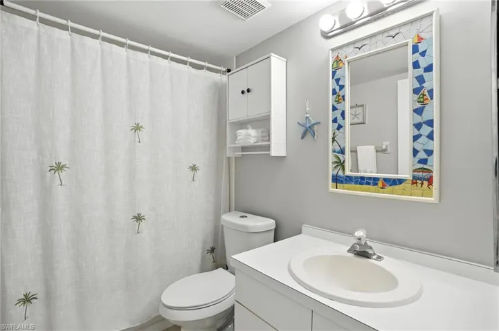 Full bath featuring vanity and curtained shower