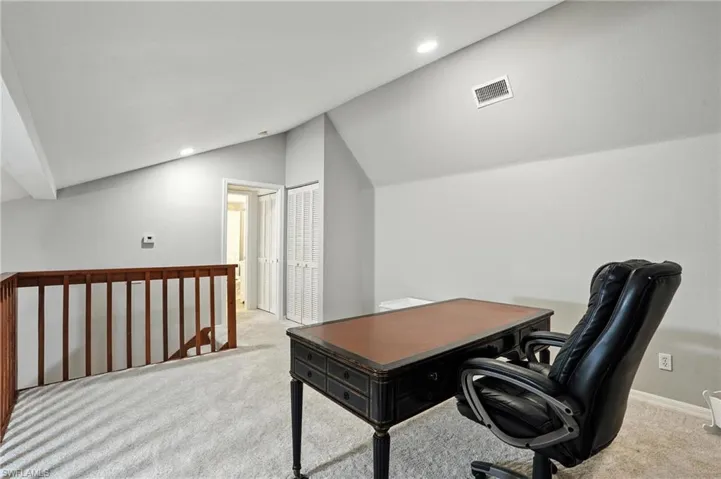 Loft with lofted ceiling and recessed lighting