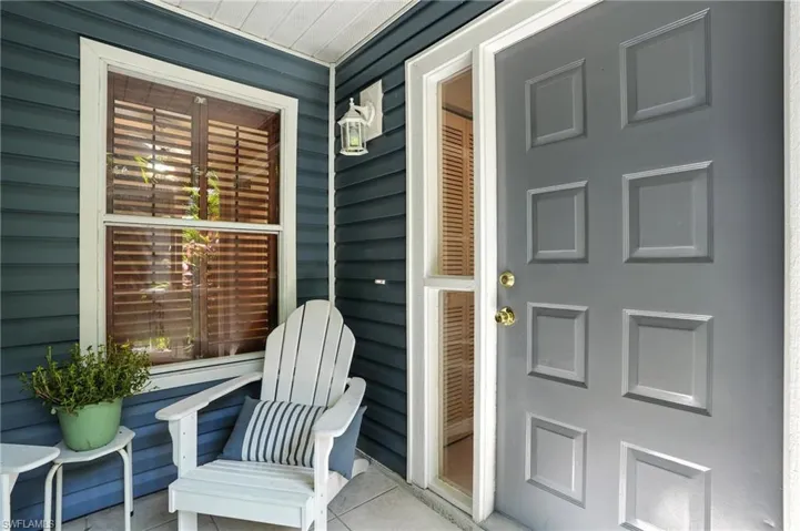 Doorway to property featuring covered porch