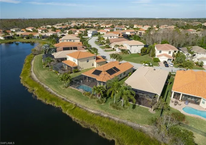 Aerial overview of property's location featuring a nearby body of water and nearby suburban area