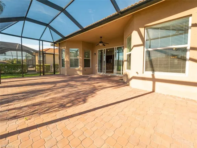 View of patio featuring ceiling fan, a lanai, and a sunroom