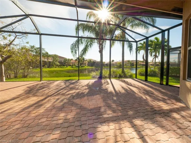 View of patio / terrace featuring a sunroom, a lanai, a water view, and a residential view