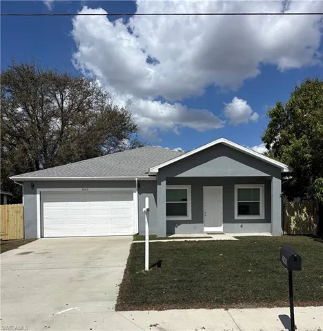 Ranch-style house featuring a porch, an attached garage, concrete driveway, stucco siding, and roof with shingles