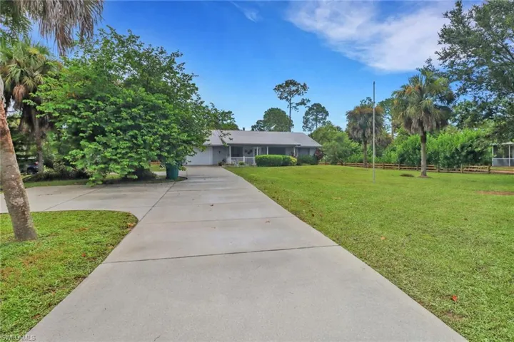 View of front of property featuring a front lawn and a garage