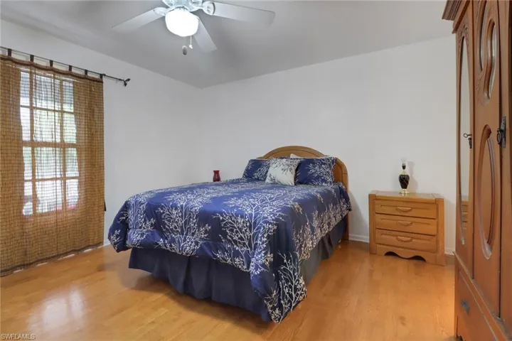 Bedroom featuring ceiling fan and light hardwood / wood-style flooring