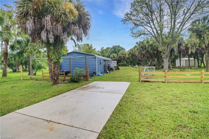View of yard with an outbuilding and a garage
