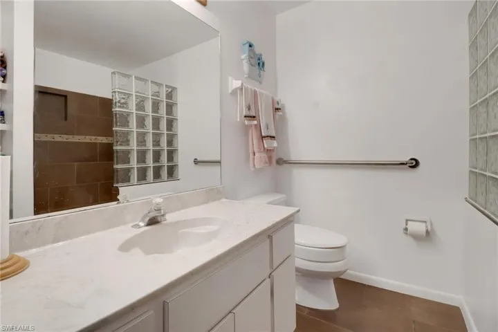 Bathroom with tile patterned flooring, vanity, and toilet