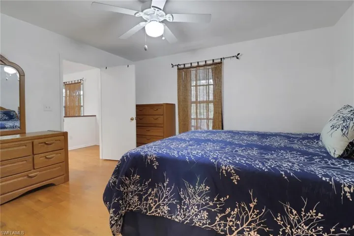 Bedroom featuring ceiling fan and wood-type flooring