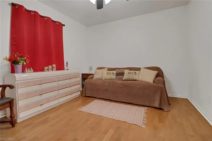 Bedroom with ceiling fan and wood-type flooring