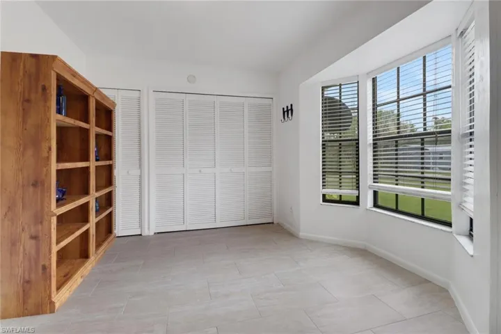 Unfurnished bedroom featuring multiple closets and light tile patterned floors