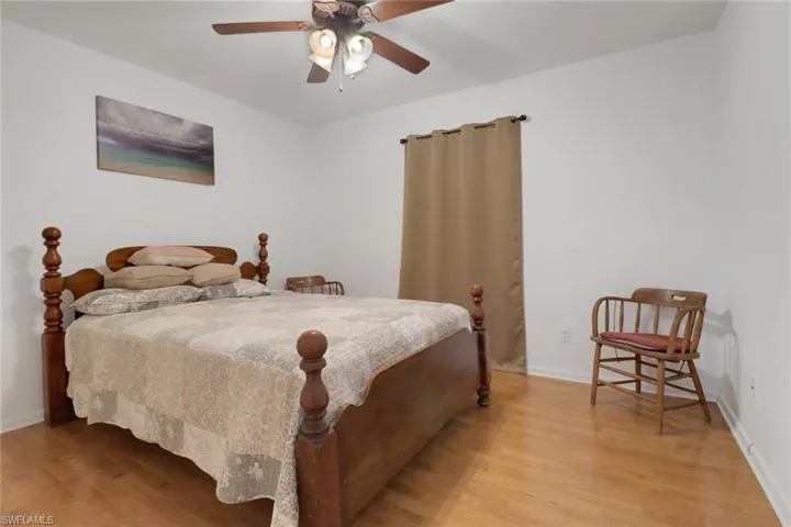Bedroom with ceiling fan and light hardwood / wood-style flooring