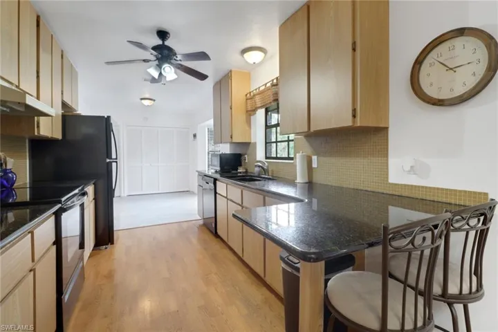 Kitchen featuring sink, light hardwood / wood-style floors, light brown cabinets, ceiling fan, and range with electric stovetop