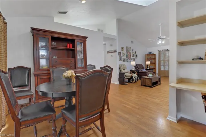 Dining room featuring ceiling fan, light hardwood / wood-style flooring, and lofted ceiling