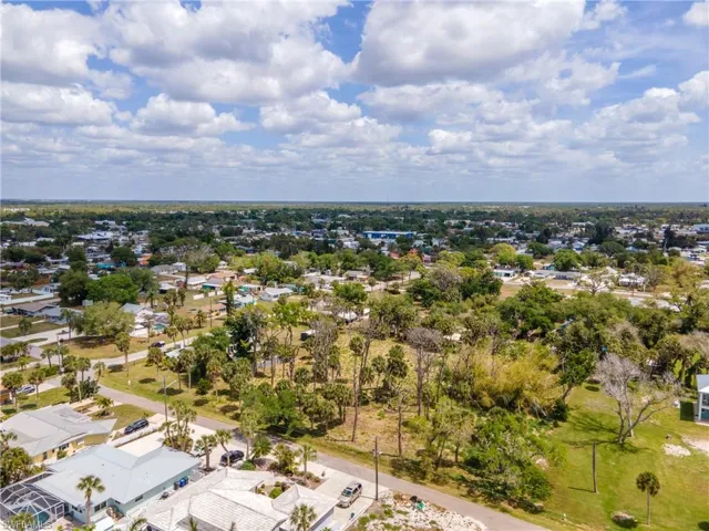 Expansive lot featuring mature trees and a flat topography, suitable for new construction