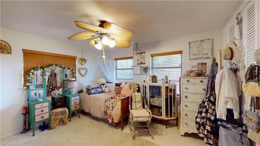Bedroom featuring ceiling fan and carpet floors