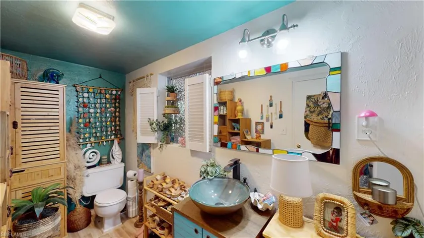 Bathroom featuring walk in shower, vanity, and toilet